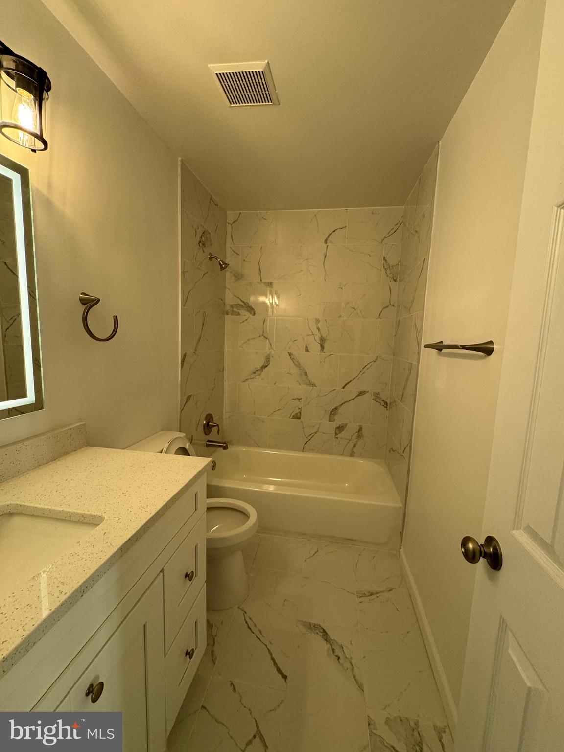 1202 Barnaby Terrace Southeast Washington, DC 20032 - Photo 11 of 21 a bathroom with a granite countertop sink a toilet and shower
