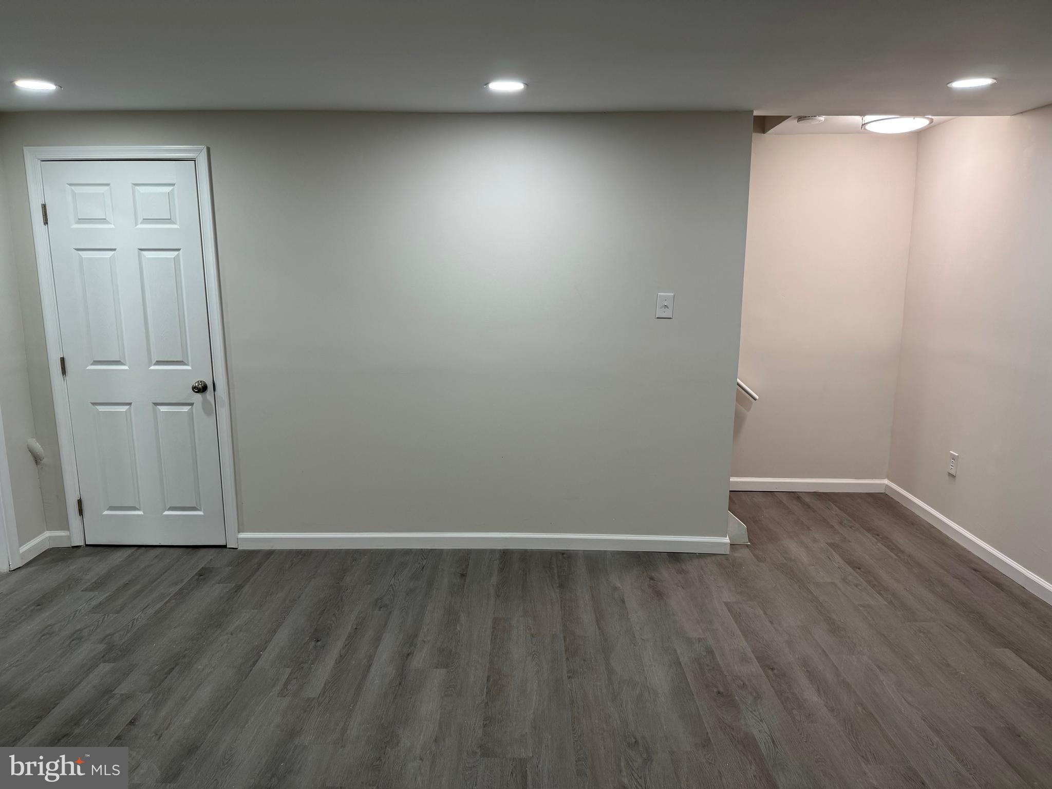 1202 Barnaby Terrace Southeast Washington, DC 20032 - Photo 15 of 21 an empty room with wooden floor and white walls