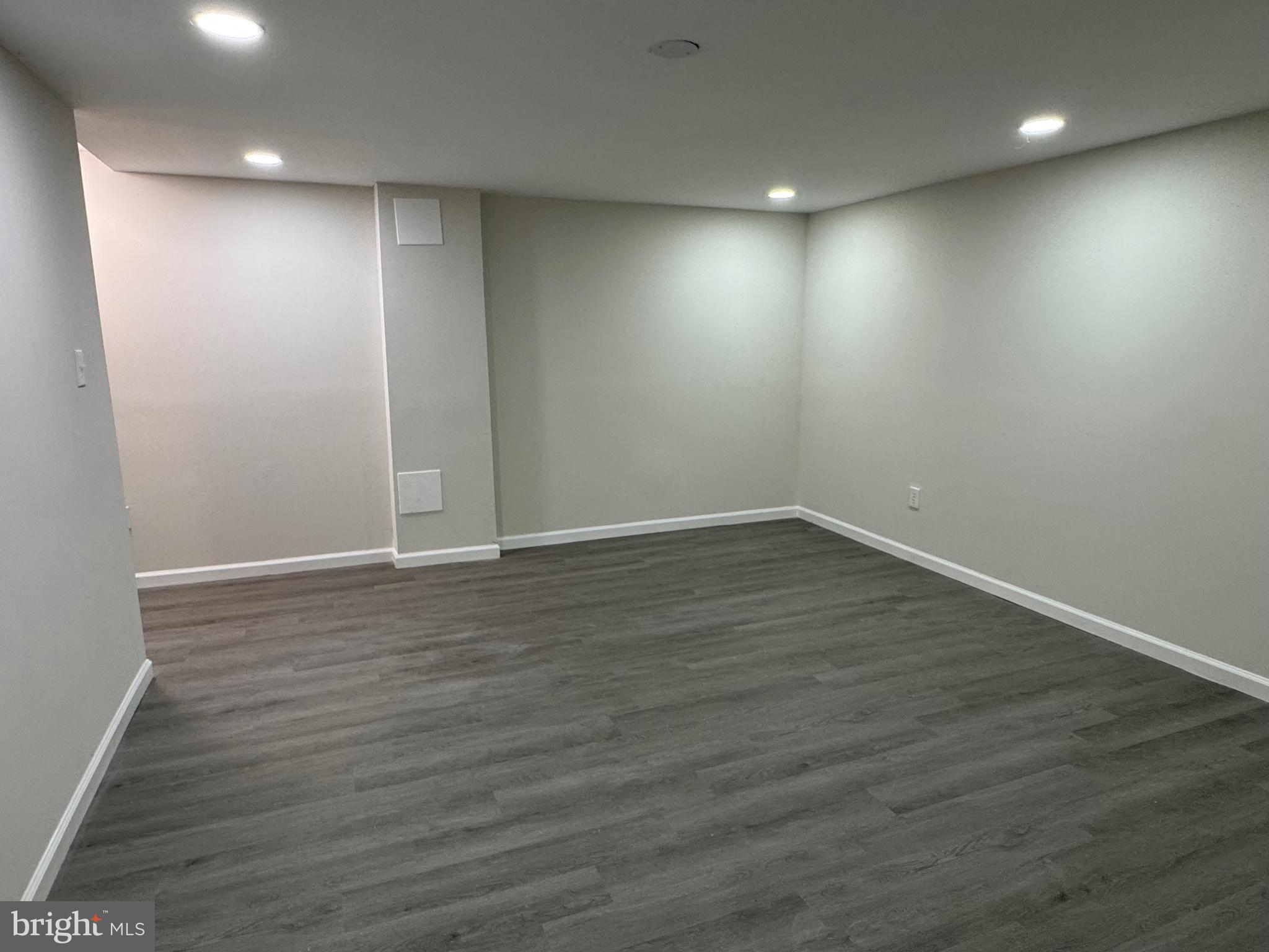 1202 Barnaby Terrace Southeast Washington, DC 20032 - Photo 16 of 21 an empty room with wooden floor and windows