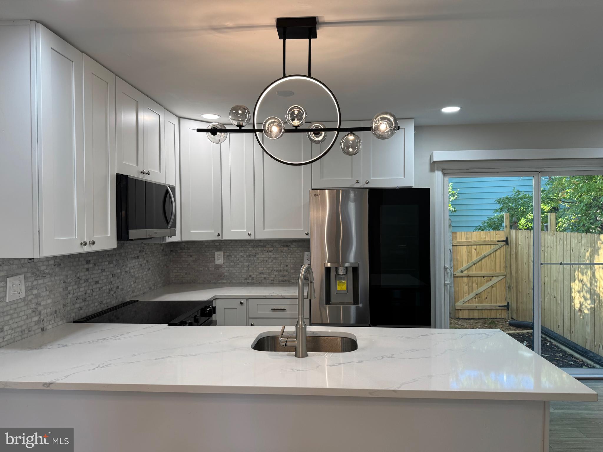 1202 Barnaby Terrace Southeast Washington, DC 20032 - Photo 2 of 21 a kitchen with a refrigerator a sink and cabinets