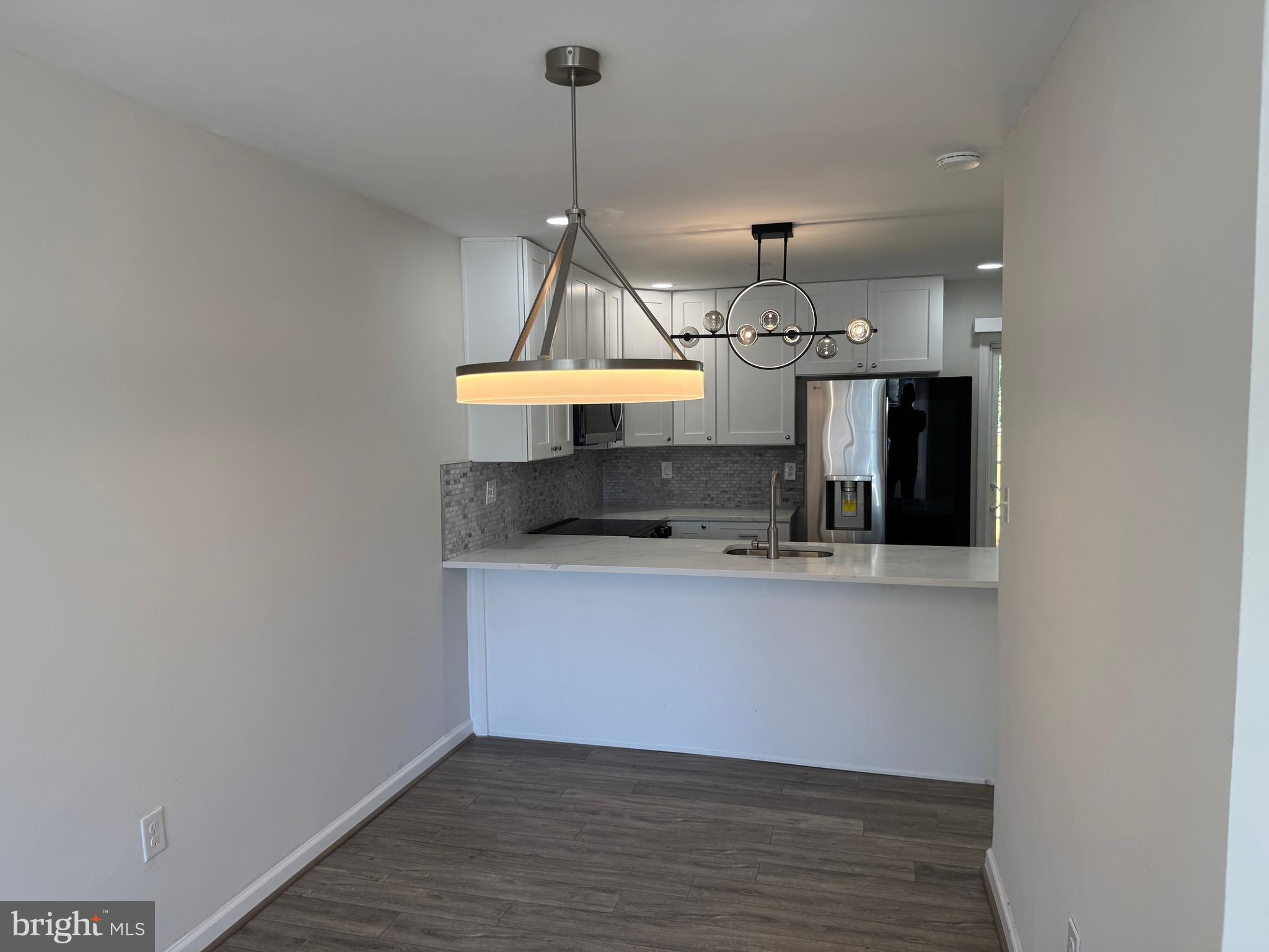 1202 Barnaby Terrace Southeast Washington, DC 20032 - Photo 4 of 21 a room with stainless steel appliances wooden floor and a view of kitchen