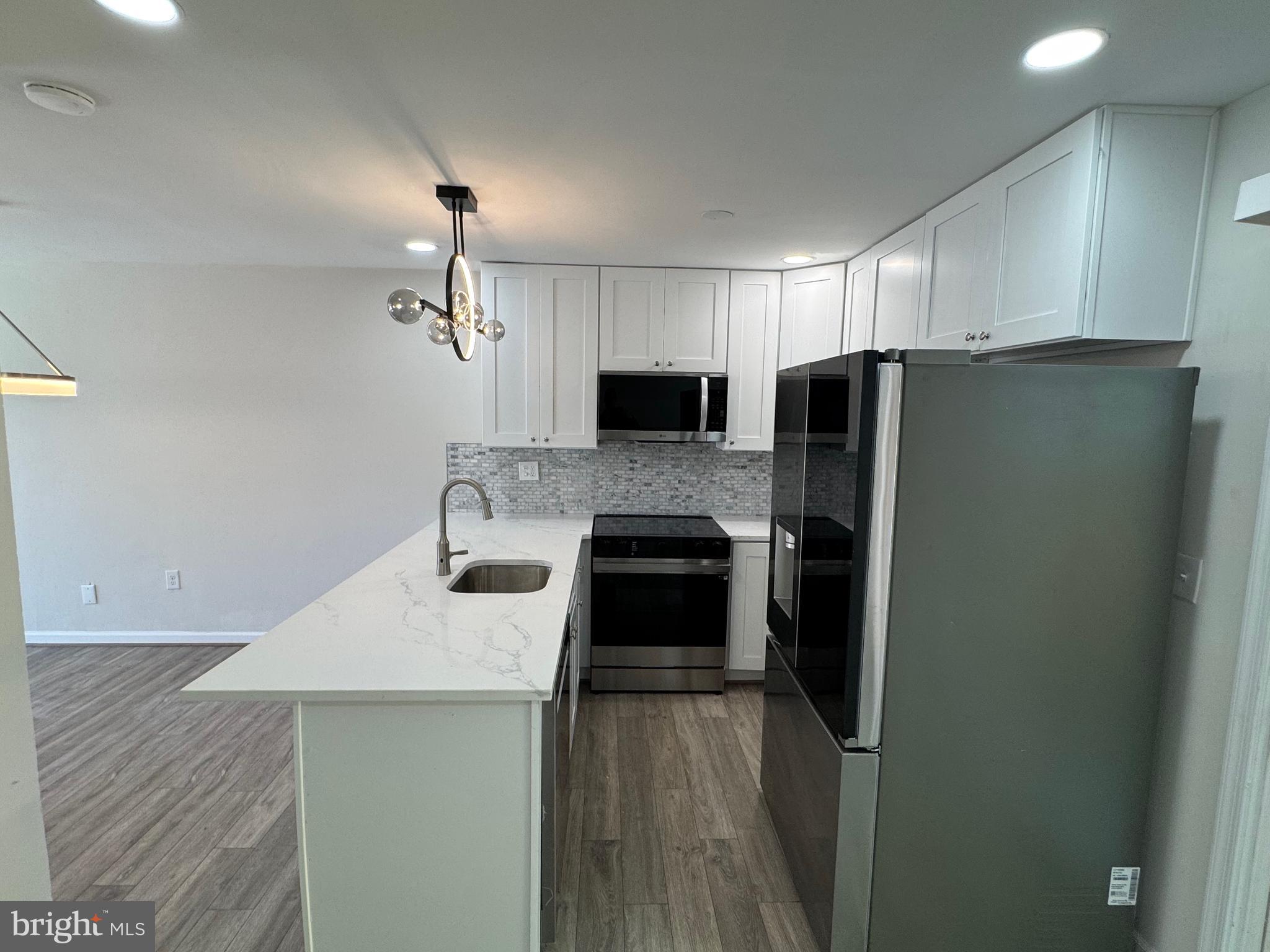 1202 Barnaby Terrace Southeast Washington, DC 20032 - Photo 5 of 21 a kitchen with a refrigerator sink and stove