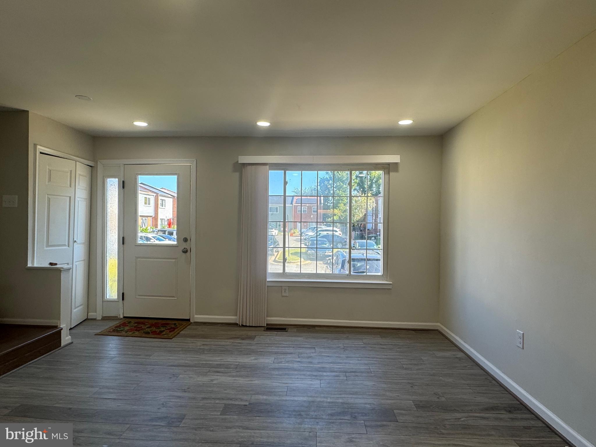 1202 Barnaby Terrace Southeast Washington, DC 20032 - Photo 7 of 21 an empty room with wooden floor and windows