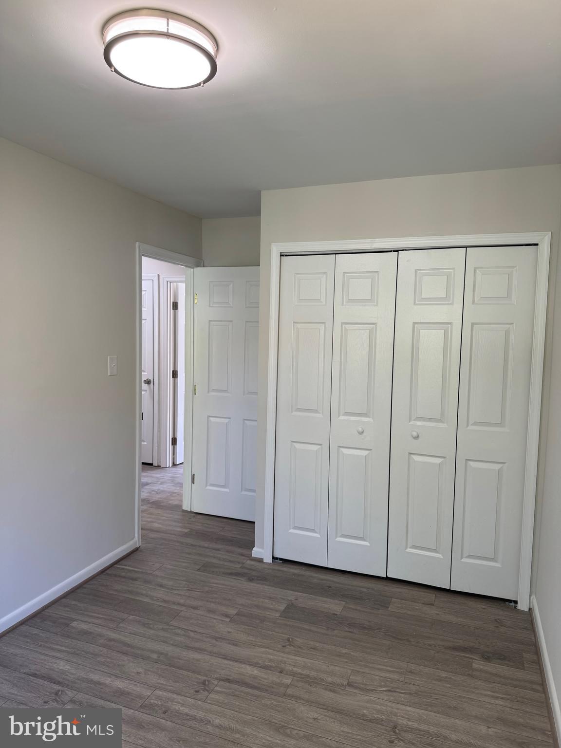 1202 Barnaby Terrace Southeast Washington, DC 20032 - Photo 10 of 21 a view of an empty room and wooden floor