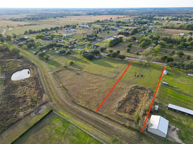 an aerial view of a residential houses with outdoor space