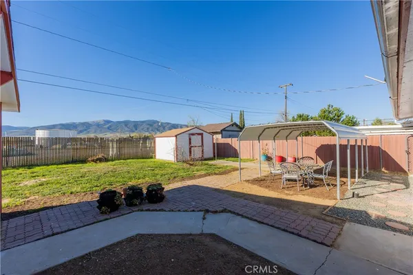 a view of an house with backyard and sitting area