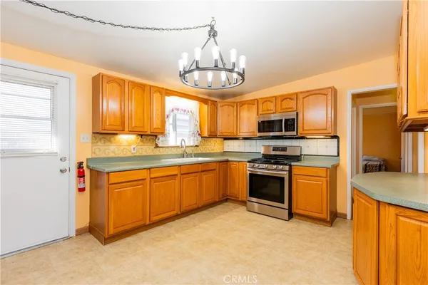 a kitchen with stainless steel appliances granite countertop a stove and a sink