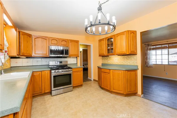 a kitchen with stainless steel appliances granite countertop a stove and a sink