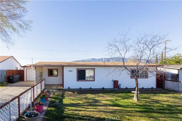 a view of a house with swimming pool and a yard