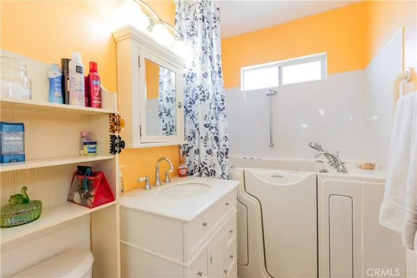 a view of washer and dryer with kitchen in the background