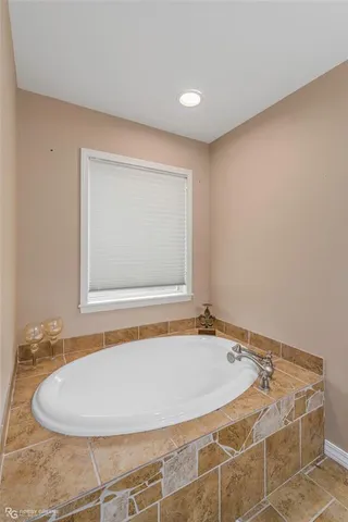 a bathroom with a tub and shower