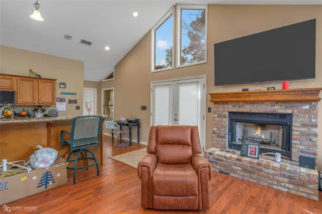 a living room with furniture fireplace and flat screen tv