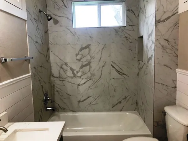 a bathroom with a bathtub and a shower
