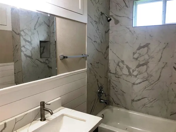 a bathroom with a sink and shower