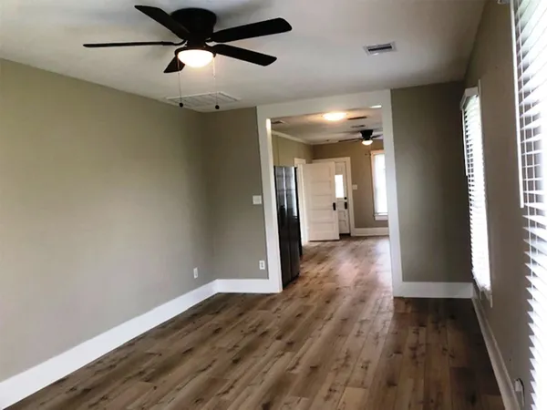 a view of hallway with wooden floor