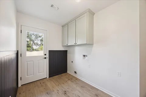 a view of a kitchen with wooden floor and window