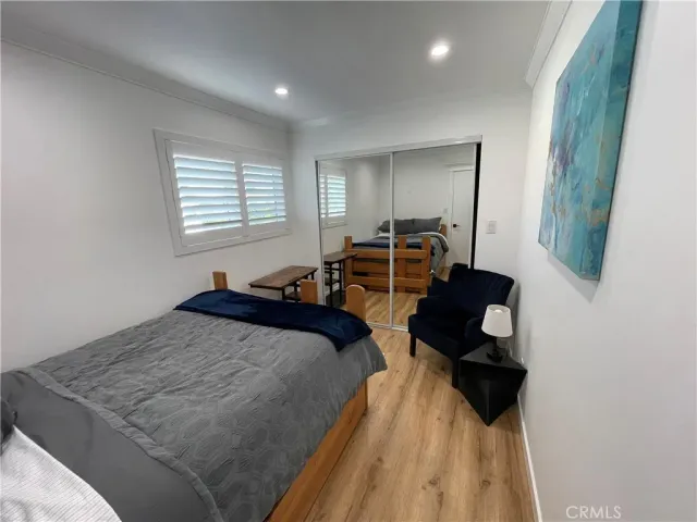 a bedroom with two beds and a dresser