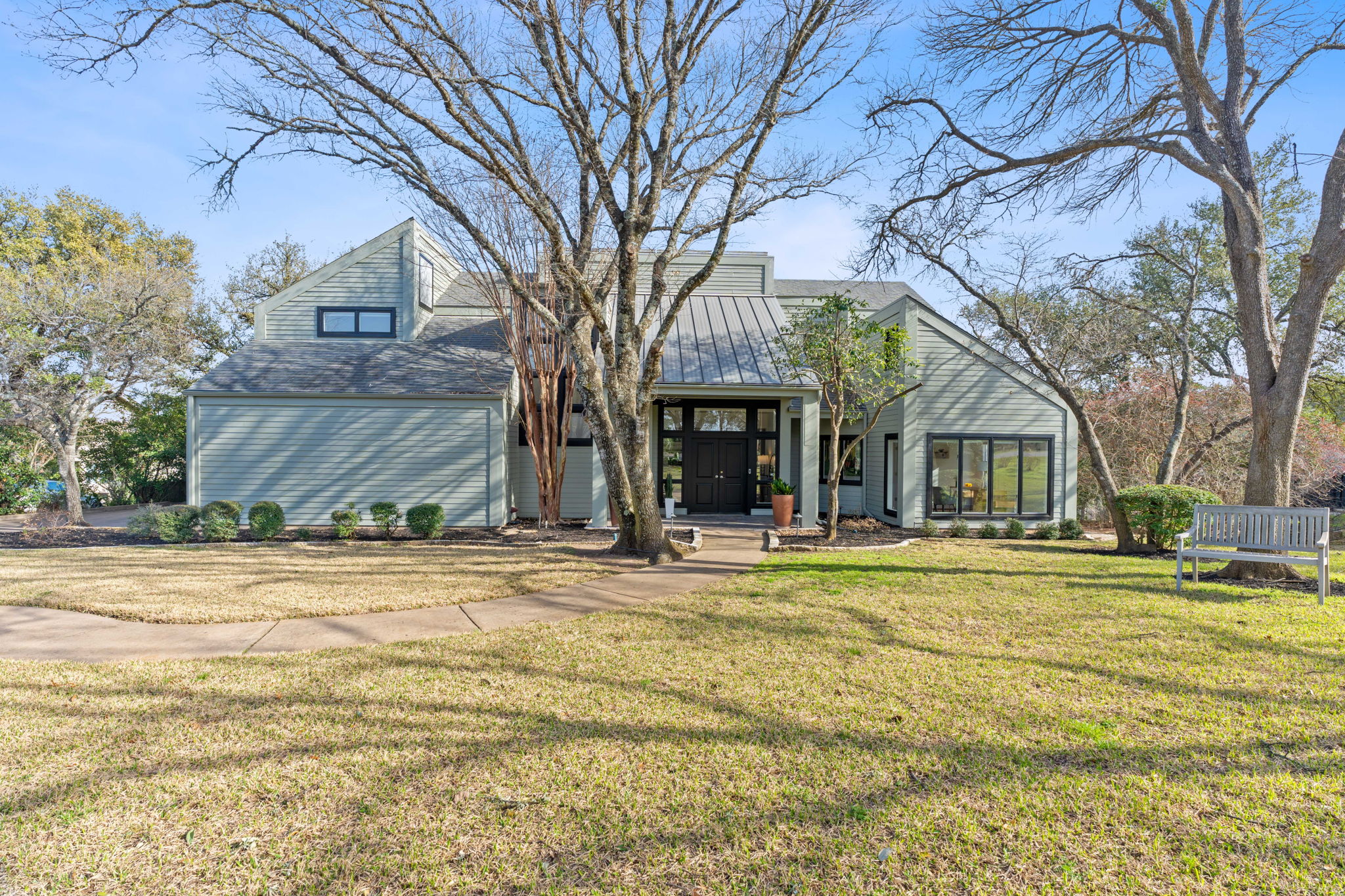 1802 Yaupon Valley Road Austin, TX 78746 - Photo 1 of 1 a front view of a house with a garden