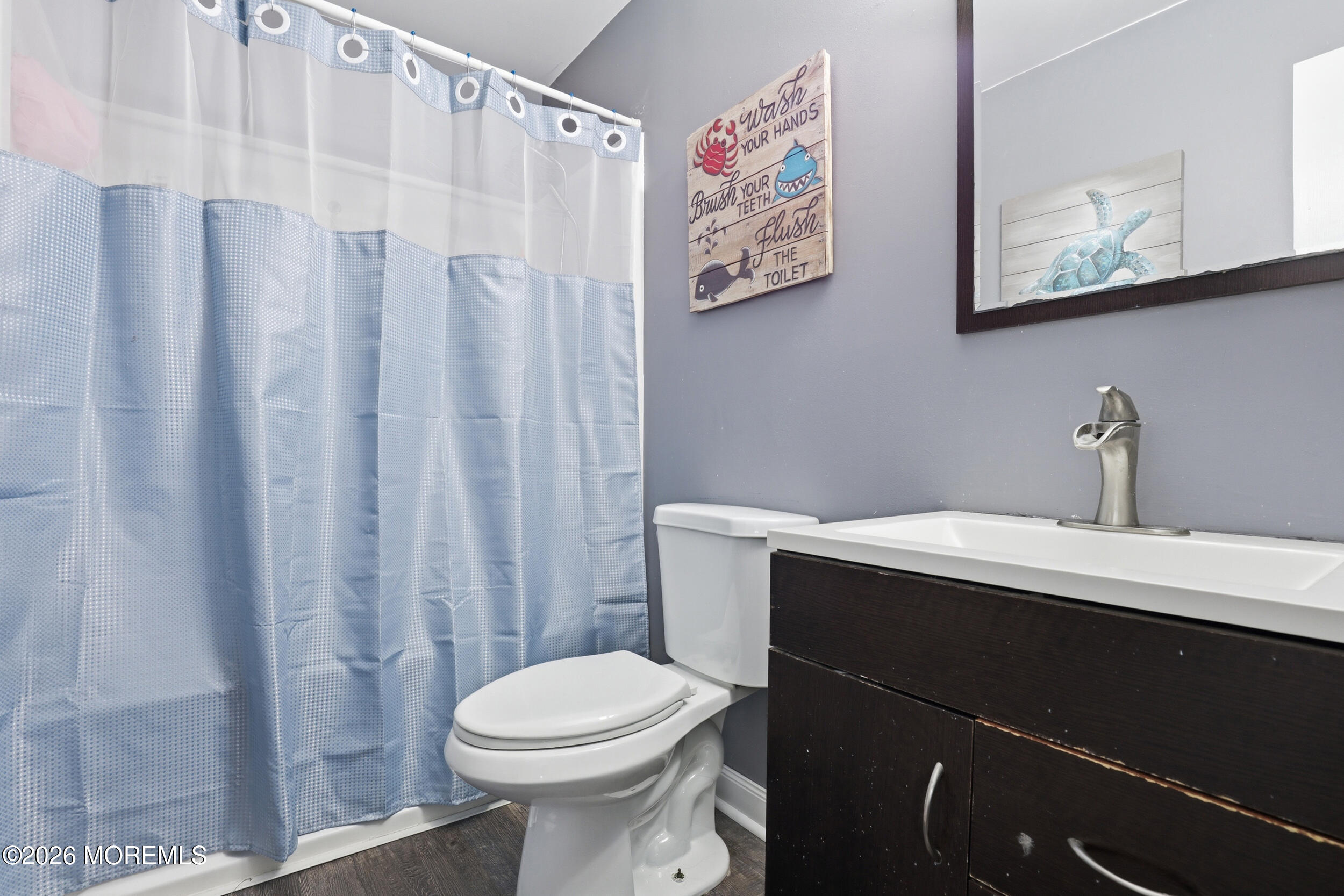 306 Ashford Road Toms River, NJ 08755 - Photo 18 of 33 a bathroom with a sink a toilet and shower curtain