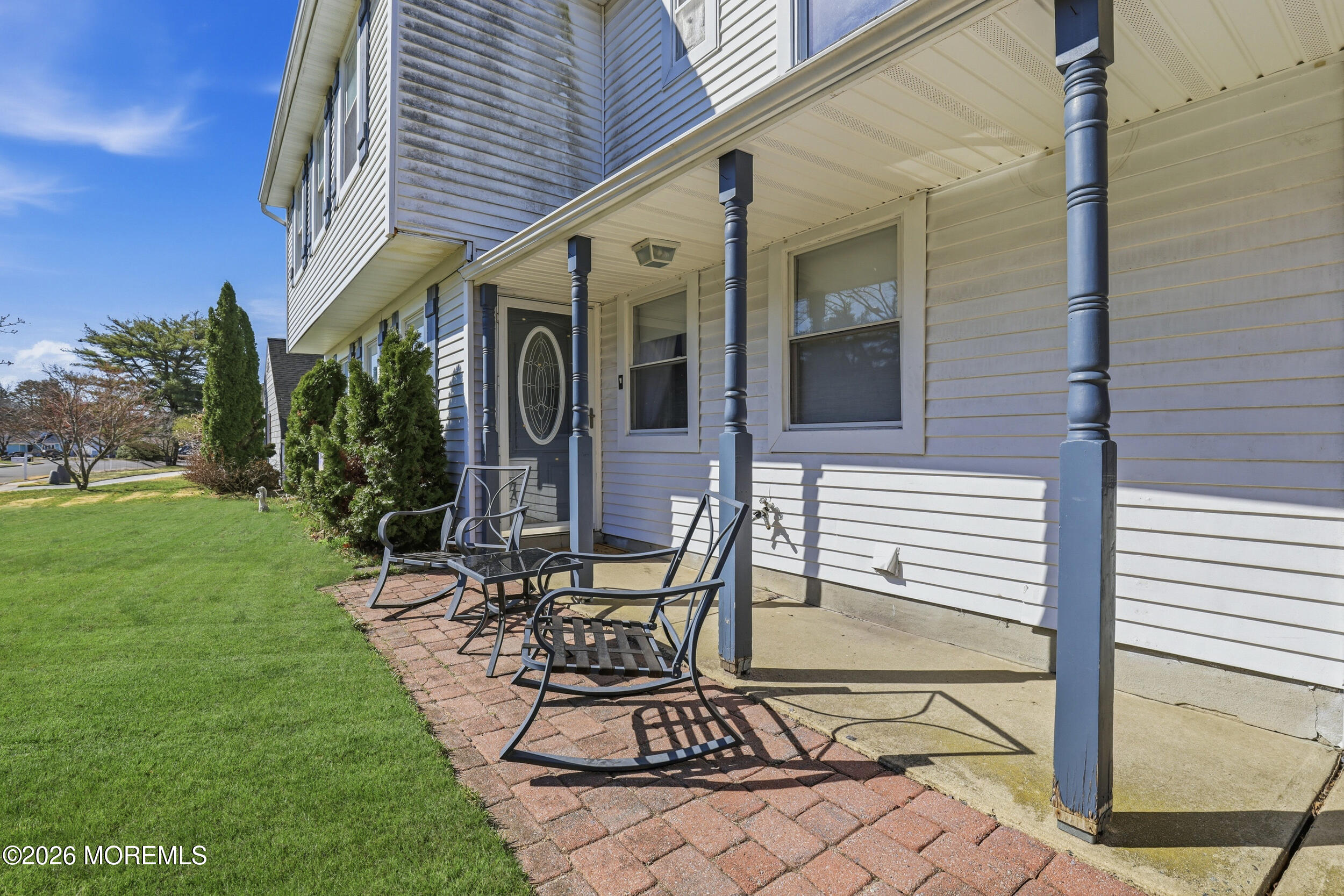 306 Ashford Road Toms River, NJ 08755 - Photo 4 of 33 a view of a patio with table and chairs with plants and wooden fence