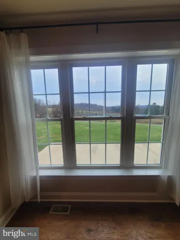 a spacious bedroom with a bed and a chandelier