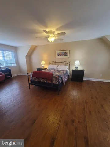 a large bed sitting in a bedroom next to a window