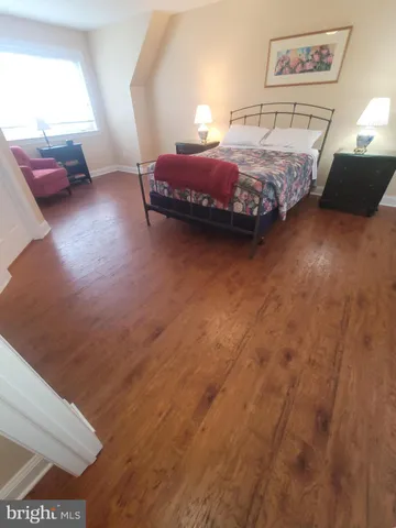 a bedroom with a bed and a view of kitchen