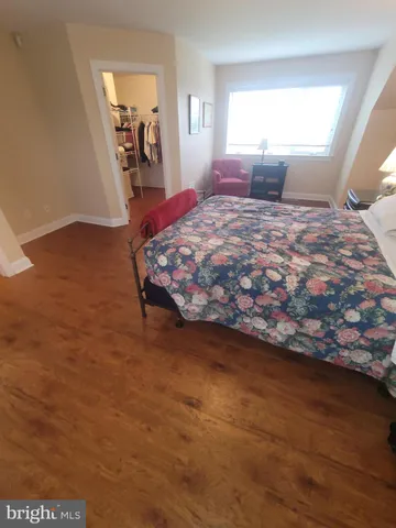 a bedroom with furniture and a window