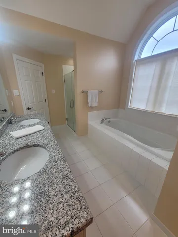 a view of staircase with railing and white walls