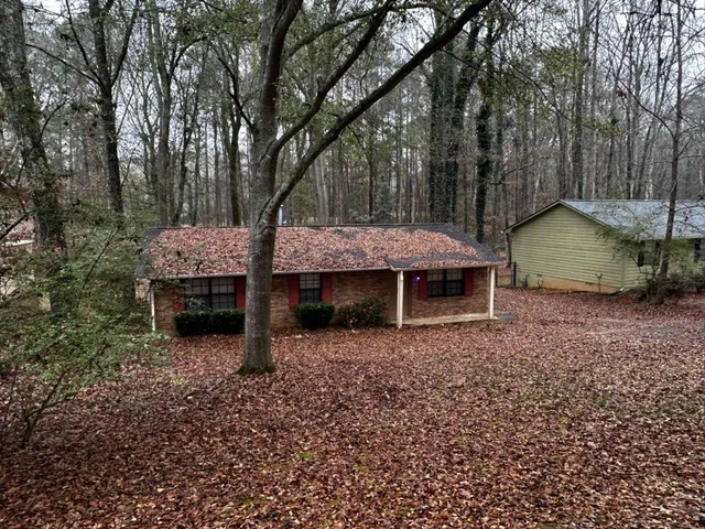 a backyard of a house with table and chairs