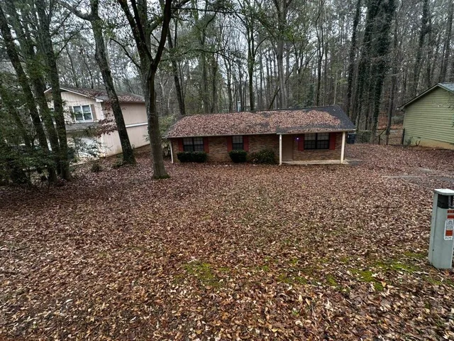 a wooden bench sitting in front of a house