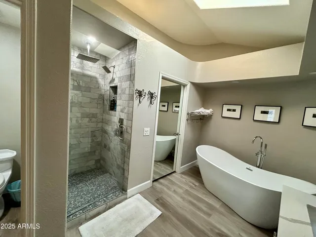 a bathroom with a bathtub and a shower