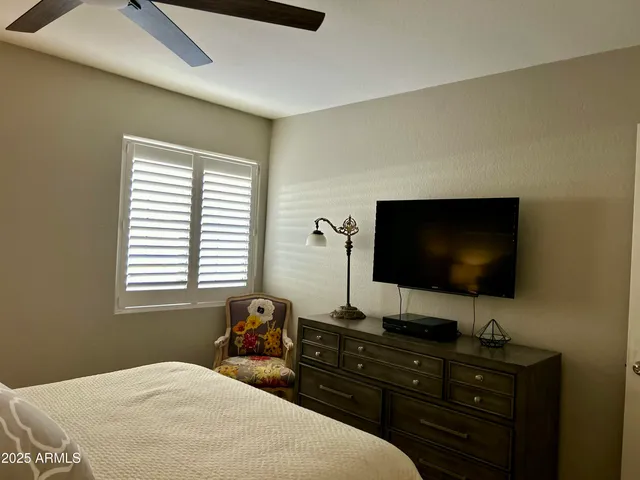 a bedroom with a flat screen tv and a bed