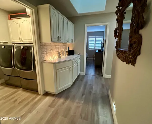 a kitchen with a sink a refrigerator and cabinets