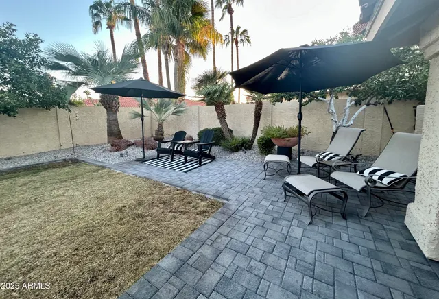 a view of a backyard with sitting area