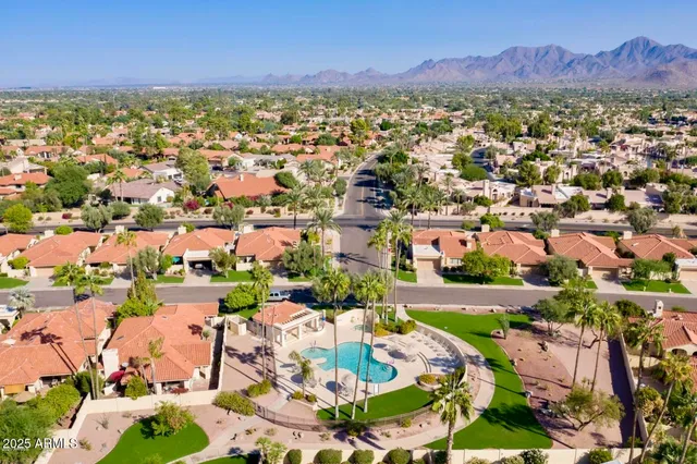 an aerial view of residential houses with outdoor space
