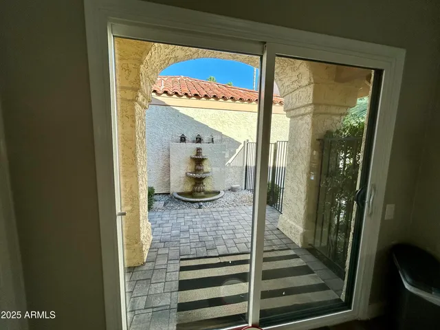 a view of a hallway with wooden floor and a living room