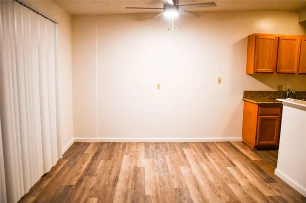 a view of a room with wooden floor and a sink
