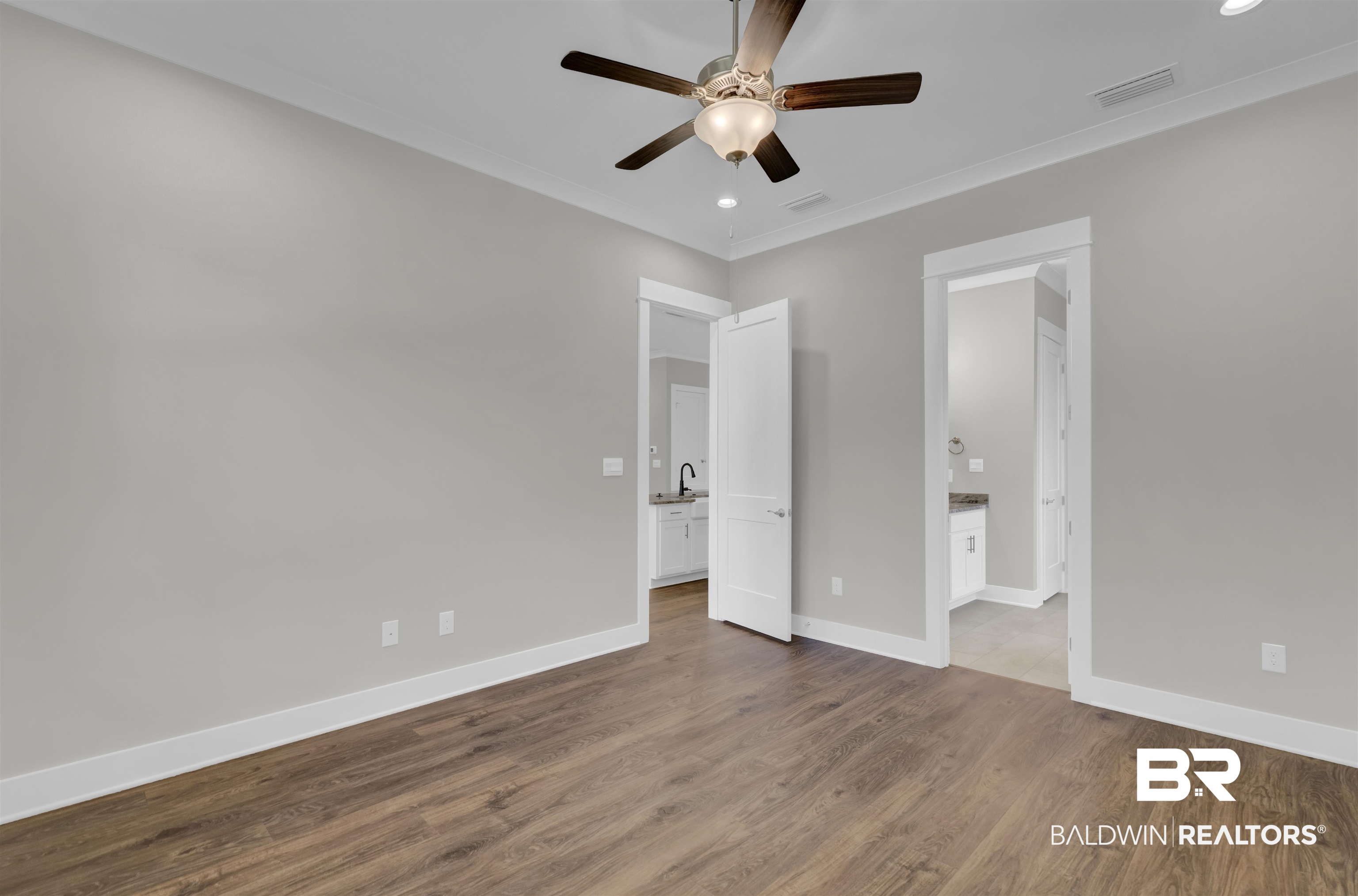 571 Morning Mist Way Fairhope, AL 36532 - Photo 19 of 47 Unfurnished bedroom featuring dark wood-type flooring, ceiling fan, recessed lighting, ornamental molding, and connected bathroom