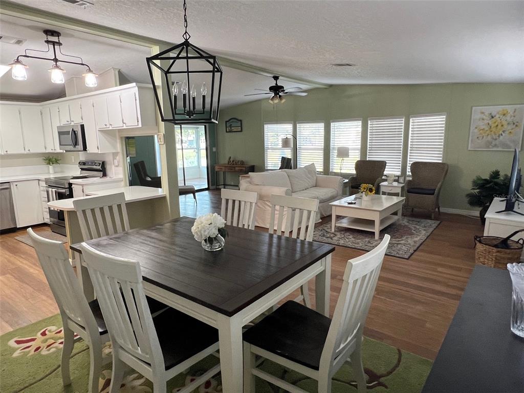 1001 Starkey Road, Unit 177 Largo, FL 33771 - Photo 12 of 44 a view of a dining room with furniture window and wooden floor