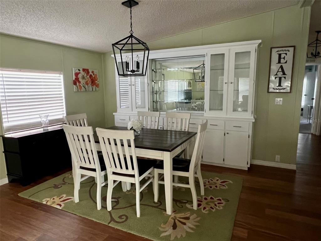 1001 Starkey Road, Unit 177 Largo, FL 33771 - Photo 13 of 44 a view of a dining room with furniture window and wooden floor