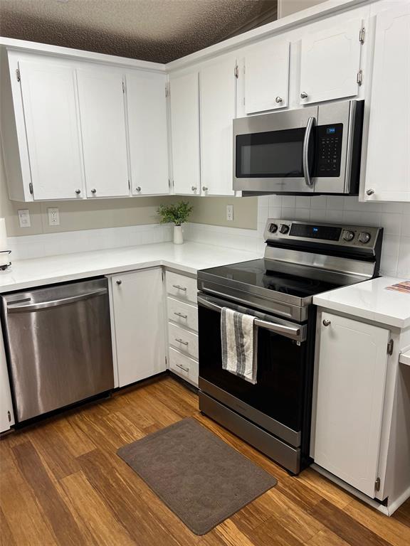 1001 Starkey Road, Unit 177 Largo, FL 33771 - Photo 6 of 44 a kitchen with granite countertop a stove top oven microwave and cabinets