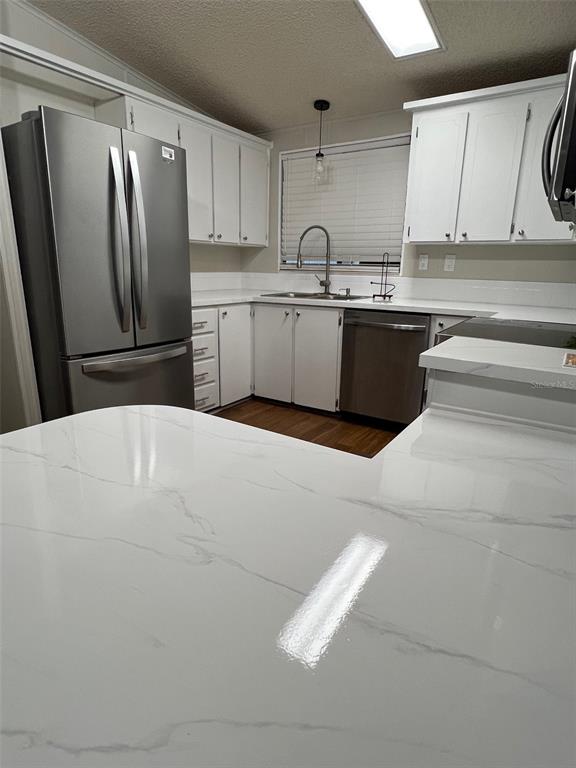 1001 Starkey Road, Unit 177 Largo, FL 33771 - Photo 7 of 44 a kitchen with stainless steel appliances a sink a refrigerator and a window