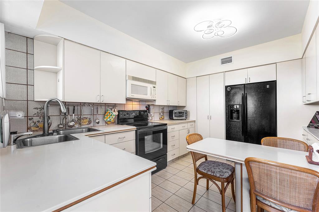 1900 South Ocean Drive, Unit 812 Fort Lauderdale, FL 33316 - Photo 16 of 65 a kitchen with a refrigerator and a stove top oven
