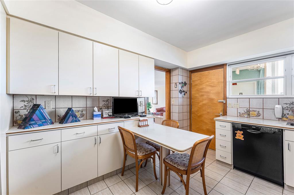 1900 South Ocean Drive, Unit 812 Fort Lauderdale, FL 33316 - Photo 17 of 65 a kitchen with a stove a sink and white cabinets with wooden floors