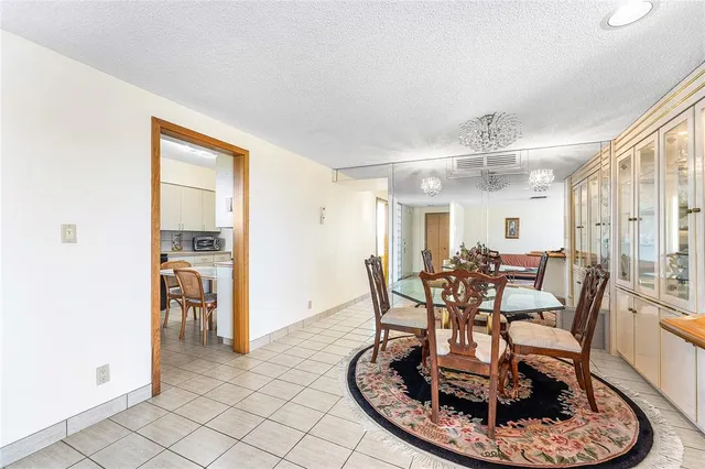 a living room with furniture a flat screen tv and a large window