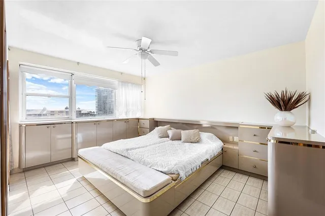 a view of a bedroom with a bed and a window