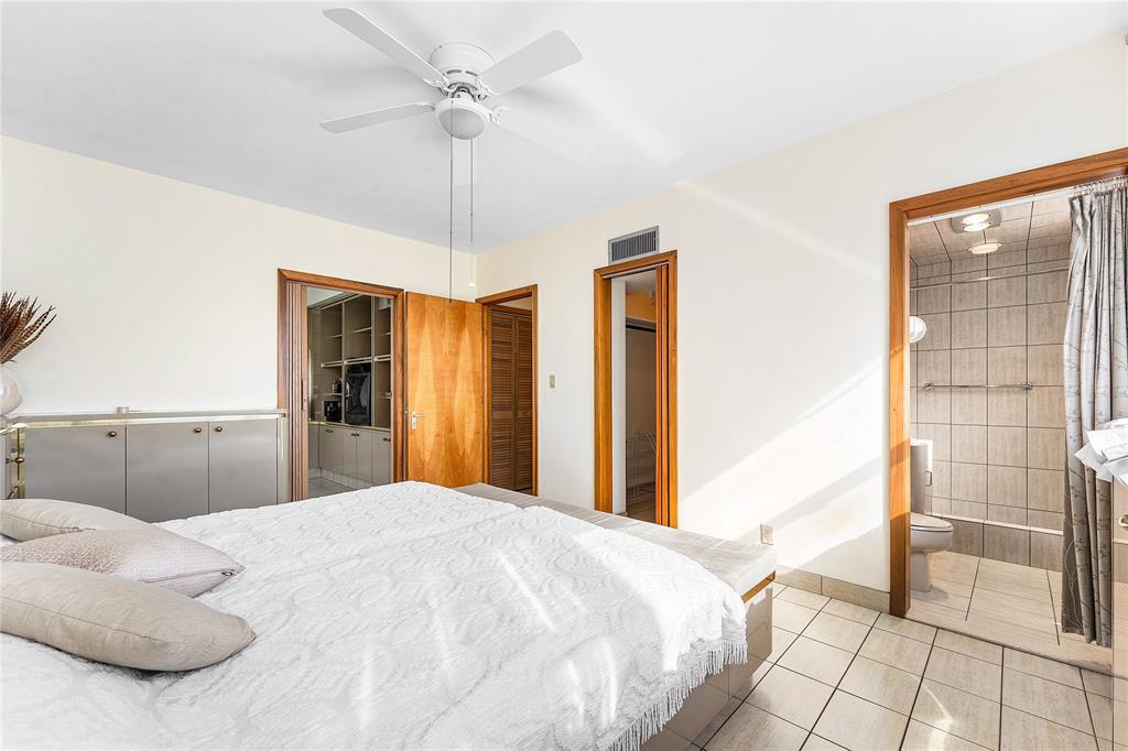 1900 South Ocean Drive, Unit 812 Fort Lauderdale, FL 33316 - Photo 29 of 65 a bedroom with a bed and a walk in closet