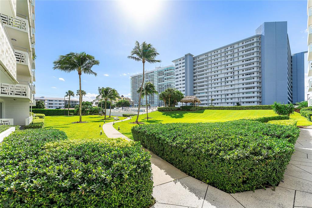 1900 South Ocean Drive, Unit 812 Fort Lauderdale, FL 33316 - Photo 50 of 65 a view of a swimming pool with a yard and palm trees