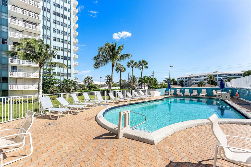 1900 South Ocean Drive, Unit 812 Fort Lauderdale, FL 33316 - Photo 52 of 65 a swimming pool with outdoor seating and yard